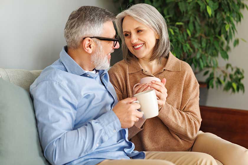 Loving senior family couple drinking tea and embracing